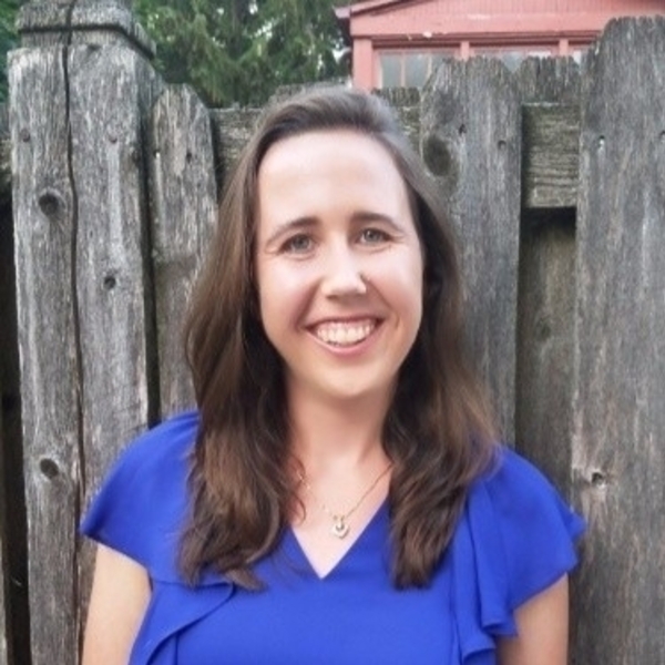 Olivia Morris in a blue top smiling.