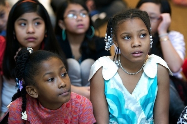 A group of children listening to a reading.